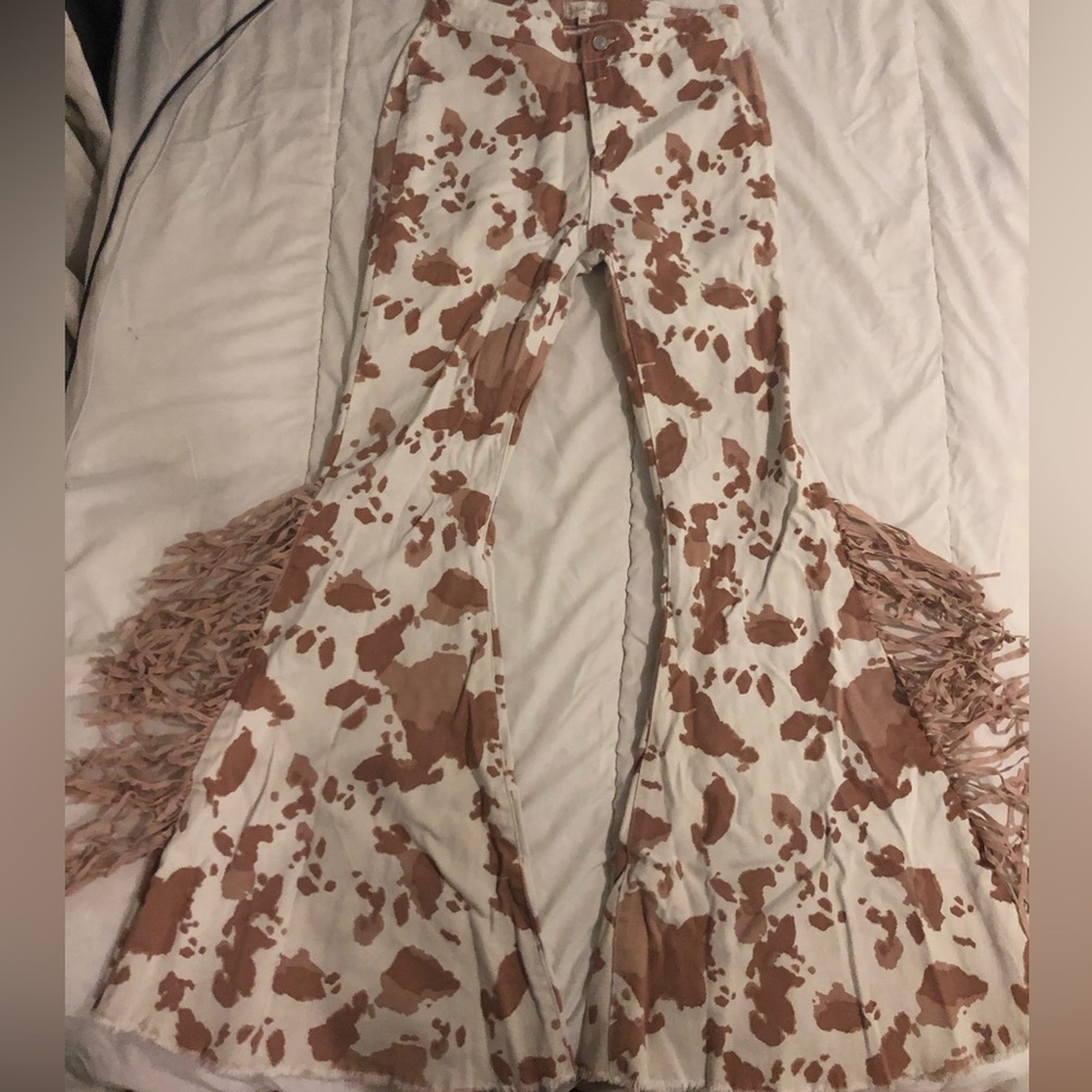 Tan cow print bell bottoms with fringe